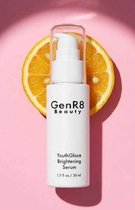 GenR8 Beauty serum bottle with a sliced orange on a pink background